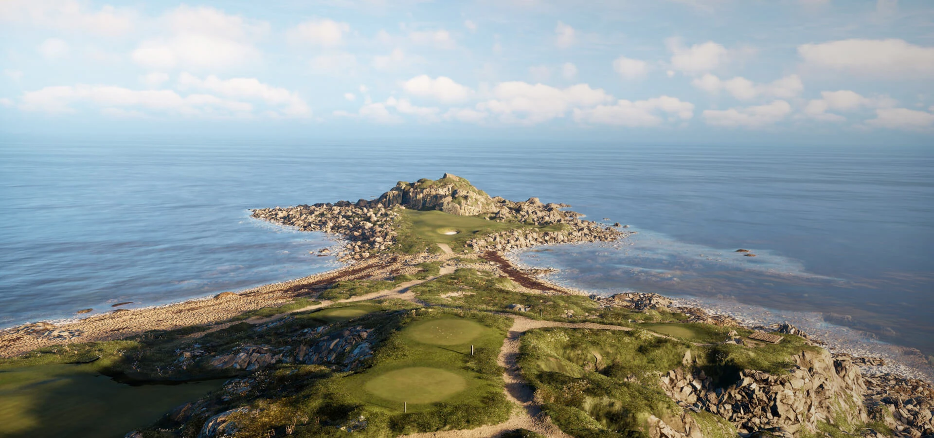 Rocky coastal landscape with green grass patches extending into a calm blue sea under a partly cloudy sky.