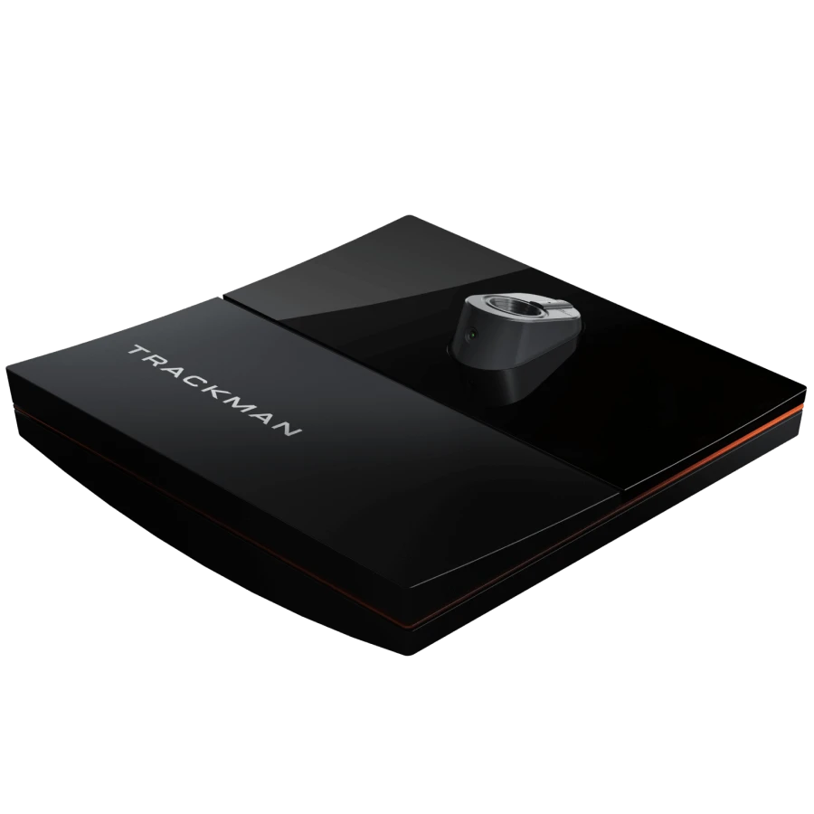 A sleek black Trackman device on a dark surface, featuring a triangular design with a central sensor.